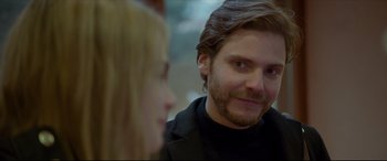 Movie still from “The Face of an Angel” (2014), directed by Michael Winterbottom – A person with long hair and a beard; Close Up shot, Over the shoulder angle