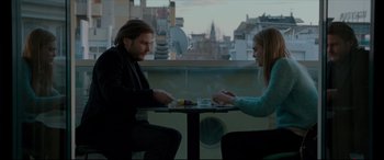 Movie still from “The Face of an Angel” (2014), directed by Michael Winterbottom – A man and a woman sitting at a table; Medium shot, Low angle