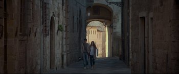 Movie still from “The Face of an Angel” (2014), directed by Michael Winterbottom – A man and a woman walking down a street; Wide shot, High angle