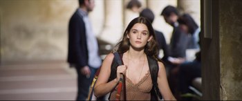 Movie still from “The Face of an Angel” (2014), directed by Michael Winterbottom – A woman walking down a street holding a backpack; Medium shot, Low angle