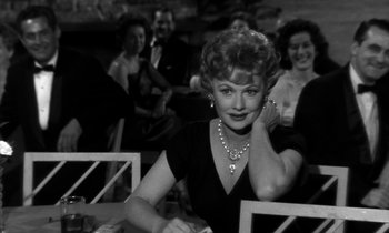 Movie still from “The Facts of Life” (1960), directed by Melvin Frank – An old photo of a woman sitting at a table; Medium shot, Over the shoulder angle