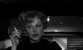 Movie still from “The Facts of Life” (1960), directed by Melvin Frank – An old photo of a woman in a car; Close Up shot, Over the shoulder angle