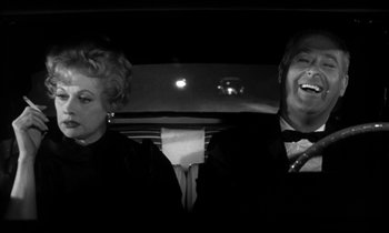 Movie still from “The Facts of Life” (1960), directed by Melvin Frank – A man and a woman sitting in the back of a car; Medium shot, Over the shoulder angle