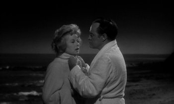 Movie still from “The Facts of Life” (1960), directed by Melvin Frank – A man and a woman standing next to each other on the beach; Medium shot, Low angle