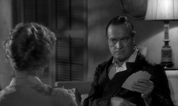 Movie still from “The Facts of Life” (1960), directed by Melvin Frank – An old photo of a man and a woman looking at each other; Medium shot, Over the shoulder angle