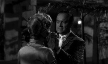 Movie still from “The Facts of Life” (1960), directed by Melvin Frank – An older woman putting a tie on a younger man; Close Up shot, Over the shoulder angle