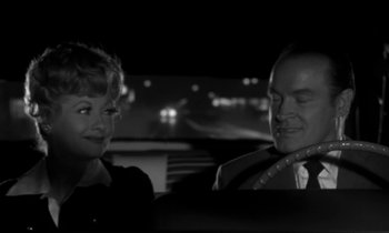 Movie still from “The Facts of Life” (1960), directed by Melvin Frank – A man and a woman sitting in the back of a car; Medium shot, Over the shoulder angle