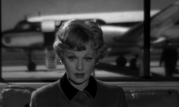 Movie still from “The Facts of Life” (1960), directed by Melvin Frank – A black - and - white photo of a woman in a dress; Close Up shot, Over the shoulder angle