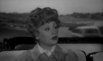 Movie still from “The Facts of Life” (1960), directed by Melvin Frank – A black - and - white photo of lucille ball; Close Up shot, Over the shoulder angle