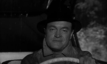 Movie still from “The Facts of Life” (1960), directed by Melvin Frank – An older man wearing a hat and driving a car; Close Up shot, High angle