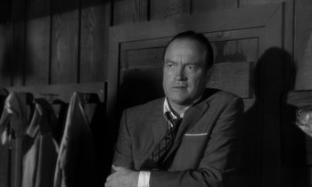 Movie still from “The Facts of Life” (1960), directed by Melvin Frank – Black and white photograph of a man wearing a suit and tie; Close Up shot, Low angle