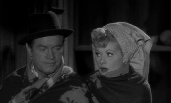 Movie still from “The Facts of Life” (1960), directed by Melvin Frank – A man and a woman sitting next to each other; Medium shot, High angle