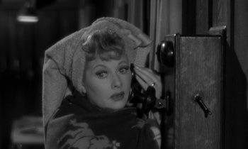 Movie still from “The Facts of Life” (1960), directed by Melvin Frank – A black - and - white photo of a woman talking on a phone; Close Up shot, High angle