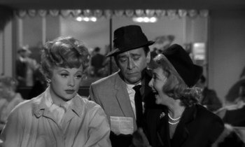 Movie still from “The Facts of Life” (1960), directed by Melvin Frank – A man and two women are talking to each other; Medium shot, Over the shoulder angle