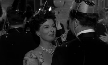 Movie still from “The Facts of Life” (1960), directed by Melvin Frank – An old photo of a man and a woman dancing at a party; Close Up shot, Over the shoulder angle