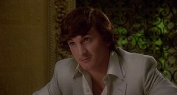 Movie still from “The Falcon and the Snowman” (1985), directed by John Schlesinger – A person wearing a suit; Close Up shot, Low angle