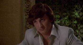 Movie still from “The Falcon and the Snowman” (1985), directed by John Schlesinger – A person wearing a suit; Close Up shot, Low angle