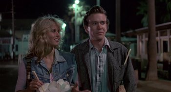 Movie still from “The Falcon and the Snowman” (1985), directed by John Schlesinger – A man and a woman standing next to each other on a street; Medium shot, Low angle