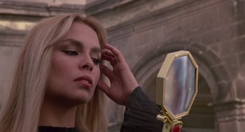 Movie still from “The Falcon and the Snowman” (1985), directed by John Schlesinger – A beautiful woman looking in a mirror; Close Up shot, Low angle