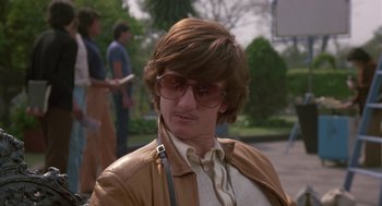 Movie still from “The Falcon and the Snowman” (1985), directed by John Schlesinger – A man in a brown jacket and sunglasses; Close Up shot, Low angle