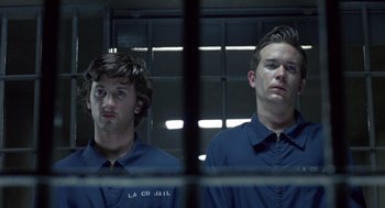 Movie still from “The Falcon and the Snowman” (1985), directed by John Schlesinger – A couple of men standing next to each other in a jail cell; Medium shot, Low angle