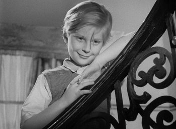 Movie still from “The Fallen Idol” (1948), directed by Carol Reed – A young boy leaning against a railing; Close Up shot, High angle