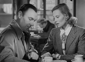 Movie still from “The Fallen Idol” (1948), directed by Carol Reed – A man and a woman sitting at a table with a cup of coffee in front of them; Medium shot, Over the shoulder angle