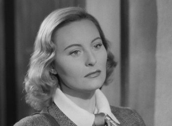 Movie still from “The Fallen Idol” (1948), directed by Carol Reed – An old photo of a woman in a suit and tie; Close Up shot, High angle