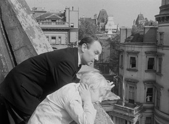 Movie still from “The Fallen Idol” (1948), directed by Carol Reed – A black and white photo of a man and a woman kissing; Medium shot, Low angle