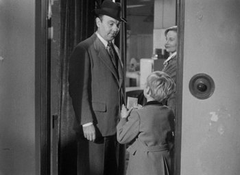 Movie still from “The Fallen Idol” (1948), directed by Carol Reed – An old photo of a man and a woman getting ready to go to work; Medium shot, Over the shoulder angle