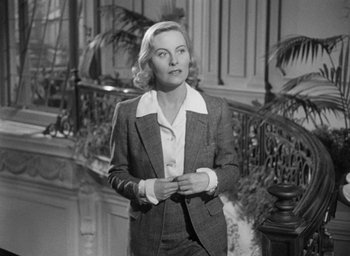 Movie still from “The Fallen Idol” (1948), directed by Carol Reed – An old photo of a woman in a suit; Medium shot, Low angle