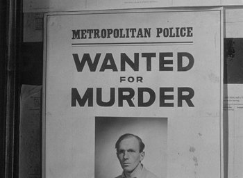 Movie still from “The Fallen Idol” (1948), directed by Carol Reed – An old wanted poster of a man in a suit; Close Up shot, Low angle