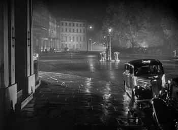 Movie still from “The Fallen Idol” (1948), directed by Carol Reed – A black - and - white photo of an empty city street; Extreme Wide shot, High angle