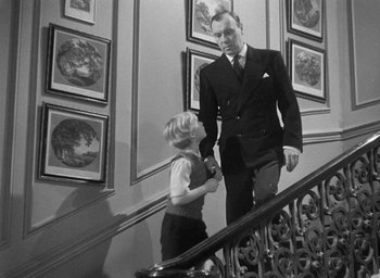 Movie still from “The Fallen Idol” (1948), directed by Carol Reed – A man and a boy walking down a staircase; Medium shot, Low angle