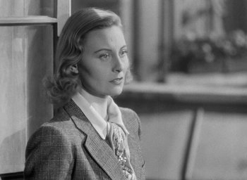 Movie still from “The Fallen Idol” (1948), directed by Carol Reed – A black and white photo of a woman wearing a suit; Close Up shot, Low angle
