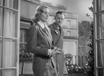 Movie still from “The Fallen Idol” (1948), directed by Carol Reed – A man and a woman standing next to each other; Medium shot, Low angle