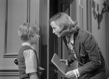 Movie still from “The Fallen Idol” (1948), directed by Carol Reed – An older woman and a young boy talking to each other; Medium shot, Over the shoulder angle