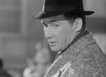 Movie still from “The Fallen Idol” (1948), directed by Carol Reed – A black and white photo of a man wearing a hat; Close Up shot, Over the shoulder angle