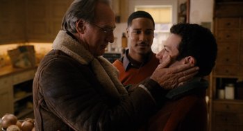 Movie still from “The Family Stone” (2005), directed by Thomas Bezucha – Two men and a man in a red shirt and a man in a brown jacket; Close Up shot, Over the shoulder angle