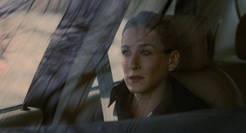 Movie still from “The Family Stone” (2005), directed by Thomas Bezucha – A woman sitting in the back seat of a car looking out the window; Close Up shot, Over the shoulder angle