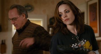 Movie still from “The Family Stone” (2005), directed by Thomas Bezucha – A woman standing next to a man in a room; Close Up shot, Over the shoulder angle