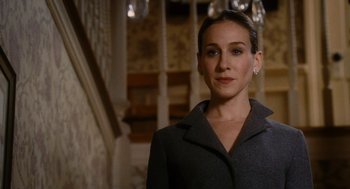 Movie still from “The Family Stone” (2005), directed by Thomas Bezucha – A woman in a gray jacket standing in front of a staircase; Close Up shot, Low angle