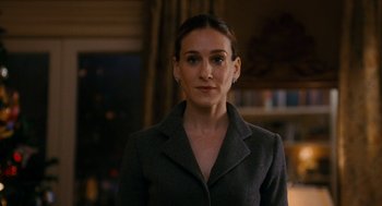 Movie still from “The Family Stone” (2005), directed by Thomas Bezucha – A woman in a gray jacket standing in front of a window; Close Up shot, Over the shoulder angle