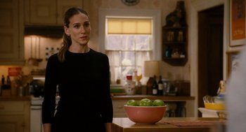 Movie still from “The Family Stone” (2005), directed by Thomas Bezucha – A woman standing next to a bowl of green apples; Medium shot, Over the shoulder angle