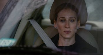 Movie still from “The Family Stone” (2005), directed by Thomas Bezucha – A person sitting in a car wearing a hat; Close Up shot, Over the shoulder angle