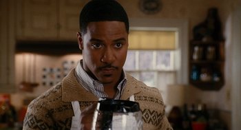 Movie still from “The Family Stone” (2005), directed by Thomas Bezucha – A man holding a coffee pot in a kitchen; Close Up shot, Over the shoulder angle