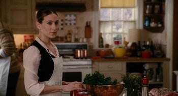 Movie still from “The Family Stone” (2005), directed by Thomas Bezucha – A woman standing in a kitchen preparing food; Medium shot, Over the shoulder angle