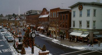 Movie still from “The Family Stone” (2005), directed by Thomas Bezucha – A christmas tree on the sidewalk of a town street; Extreme Wide shot, High angle