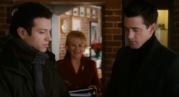 Movie still from “The Family Stone” (2005), directed by Thomas Bezucha – Two men and a woman standing in front of a brick wall; Medium shot, Over the shoulder angle