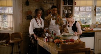 Movie still from “The Family Stone” (2005), directed by Thomas Bezucha – A group of people standing around a table in a kitchen; Medium shot, High angle